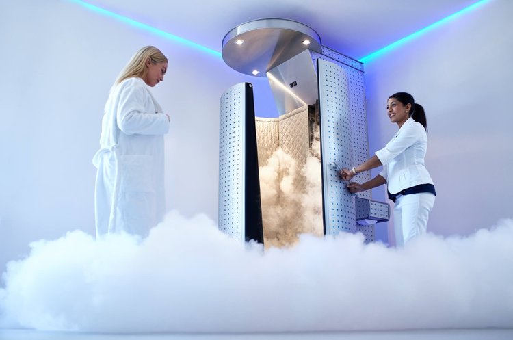 A customer getting into a nitrogen Cryotherapy chamber for weight loss, anti aging, and for less pain and inflammation.