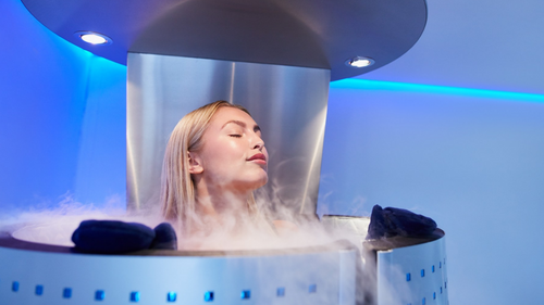 A customer inside a nitrogen based Cryotherapy chamber for weight loss, anti aging, and for less pain and inflammation.