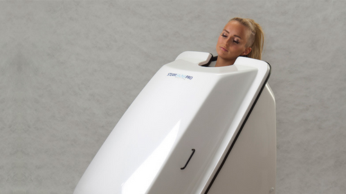 A customer in an ozone therapy unit, an infrared sauna infused with pure oxygen and ozone to help the body detox and heal.